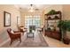Cozy living room featuring comfortable seating, large windows, and a stylish bookshelf at 6933 Cozumel Ct, Land O Lakes, FL 34637