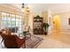 Inviting living room featuring comfortable seating, large windows, and a stylish bookshelf at 6933 Cozumel Ct, Land O Lakes, FL 34637