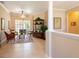Bright and airy living room featuring neutral walls, tile flooring, and seamless access to the outdoor space at 6933 Cozumel Ct, Land O Lakes, FL 34637