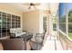 Relaxing screened-in lanai with comfortable seating, ceiling fan and view of the outdoors at 6933 Cozumel Ct, Land O Lakes, FL 34637