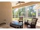 Screened-in patio area featuring comfortable seating and relaxing view at 6933 Cozumel Ct, Land O Lakes, FL 34637