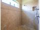 Spacious tile shower stall boasts decorative inlays and glass block window at 6933 Cozumel Ct, Land O Lakes, FL 34637
