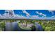 Aerial view of waterfront homes surrounded by lush greenery, highlighting the tranquil setting at 699 Merlins Ct, Tarpon Springs, FL 34689