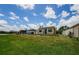 Spacious backyard featuring lush greenery, lawn, and patio at 699 Merlins Ct, Tarpon Springs, FL 34689