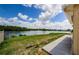 Spacious backyard featuring lush greenery and serene waterfront views at 699 Merlins Ct, Tarpon Springs, FL 34689