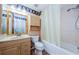 Bathroom featuring a vanity with decorative mirror and cabinet, toilet, and shower/tub at 699 Merlins Ct, Tarpon Springs, FL 34689