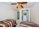 Bright bedroom with ceiling fan, closet with shelving, and beds with striped comforters at 699 Merlins Ct, Tarpon Springs, FL 34689