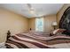 Bedroom features a decorative headboard, neutral walls, and a ceiling fan at 699 Merlins Ct, Tarpon Springs, FL 34689