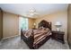 Primary bedroom featuring a ceiling fan, carpeted floors, and bedside tables with lamps at 699 Merlins Ct, Tarpon Springs, FL 34689