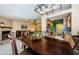 Dining room with an elegant chandelier, connecting to a cozy living room and a modern kitchen at 699 Merlins Ct, Tarpon Springs, FL 34689