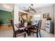 Inviting dining area adjacent to the kitchen, featuring a wooden table set with floral arrangements at 699 Merlins Ct, Tarpon Springs, FL 34689