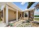 The exterior features a porch, rock accents, and flower pots that add to its curb appeal at 699 Merlins Ct, Tarpon Springs, FL 34689