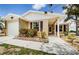 Charming single-story home with tan siding, stone accents, and a well-maintained front yard and walkway at 699 Merlins Ct, Tarpon Springs, FL 34689