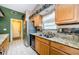 Bright kitchen featuring granite countertops, stainless steel refrigerator, and stylish backsplash details at 699 Merlins Ct, Tarpon Springs, FL 34689