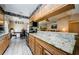 Bright eat-in kitchen featuring stainless appliances, decorative wallpaper and adjacent dining and living spaces at 699 Merlins Ct, Tarpon Springs, FL 34689