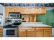 Traditional kitchen featuring granite countertops, stainless steel appliances, and wooden cabinetry at 699 Merlins Ct, Tarpon Springs, FL 34689