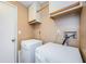 Laundry room features a washer, dryer, storage cabinets, and painted walls at 699 Merlins Ct, Tarpon Springs, FL 34689