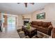 Charming living room with a fireplace, brown sofa, and sliding doors that offer a picturesque water view at 699 Merlins Ct, Tarpon Springs, FL 34689