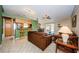 Open-concept living room with tile floors, a fireplace, and an eat-in kitchen space at 699 Merlins Ct, Tarpon Springs, FL 34689