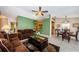 Open-concept living area with a comfortable brown sofa, stylish coffee table, and adjacent kitchen and dining area at 699 Merlins Ct, Tarpon Springs, FL 34689