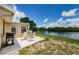 Enjoy the waterside views from the patio with a dining table and outdoor grill at 699 Merlins Ct, Tarpon Springs, FL 34689