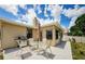 Outdoor patio area features a grill, table, umbrella, and four chairs at 699 Merlins Ct, Tarpon Springs, FL 34689