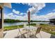 Patio area with outdoor dining set, overlooking picturesque lake views at 699 Merlins Ct, Tarpon Springs, FL 34689