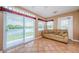 Bright sunroom with tile flooring, large sliding windows and lovely water views at 699 Merlins Ct, Tarpon Springs, FL 34689