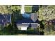 Aerial view of home showing solar panels on roof, concrete driveway, and mature landscaping at 7014 Doreen St, Tampa, FL 33617