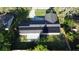 Aerial view of a home featuring solar panels on roof, patio, and fenced backyard at 7014 Doreen St, Tampa, FL 33617