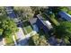 Home featuring solar panels on roof, concrete driveway, fenced yard, and mature landscaping at 7014 Doreen St, Tampa, FL 33617