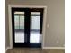 View of back porch through double doors, offering seamless indoor-outdoor flow at 7014 Doreen St, Tampa, FL 33617