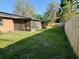Large fenced backyard featuring a screened-in porch and solar panels on the roof at 7014 Doreen St, Tampa, FL 33617