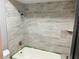 Updated bathroom showcasing newly tiled walls and a modern shower head at 7014 Doreen St, Tampa, FL 33617