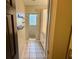 Bathroom featuring storage cabinets, a shower, and tile flooring at 7014 Doreen St, Tampa, FL 33617