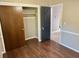 Bedroom features wood-look floors, two closets with black and brown doors at 7014 Doreen St, Tampa, FL 33617