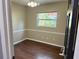 Bedroom with wood floors with view to backyard from the window at 7014 Doreen St, Tampa, FL 33617