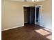 Bedroom features wood-look floors, an open closet, a ceiling fan, and black doors at 7014 Doreen St, Tampa, FL 33617