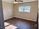 Bedroom features wood-look floors, a ceiling fan and natural light from a window at 7014 Doreen St, Tampa, FL 33617