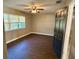 Inviting bedroom featuring hardwood flooring, a ceiling fan and a bright window at 7014 Doreen St, Tampa, FL 33617