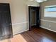Bedroom with wood floors and a closet is well-lit by window at 7014 Doreen St, Tampa, FL 33617