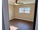 Bedroom features wood-look floors, a ceiling fan and natural light from a window at 7014 Doreen St, Tampa, FL 33617
