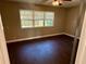 Cozy bedroom with a window for natural light and beautiful dark wood floors at 7014 Doreen St, Tampa, FL 33617