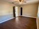Bedroom featuring neutral paint, dark wood trim, and wood-style floors at 7014 Doreen St, Tampa, FL 33617