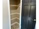 Small linen closet with tile floor and shelves at 7014 Doreen St, Tampa, FL 33617