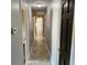 Long hallway with tile floor with doors to other rooms at 7014 Doreen St, Tampa, FL 33617
