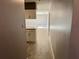 Hallway with tile floor, neutral walls, and an opening to the kitchen and the living room at 7014 Doreen St, Tampa, FL 33617