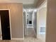 Hallway with neutral paint, a neutral tiled floor and dark doors at 7014 Doreen St, Tampa, FL 33617