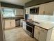 Kitchen featuring stainless steel appliances, countertops, and white cabinetry at 7014 Doreen St, Tampa, FL 33617