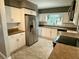 Kitchen area showcasing stainless steel appliances and white cabinets and a tiled floor at 7014 Doreen St, Tampa, FL 33617